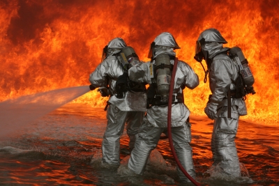 Firefighters spray large fire