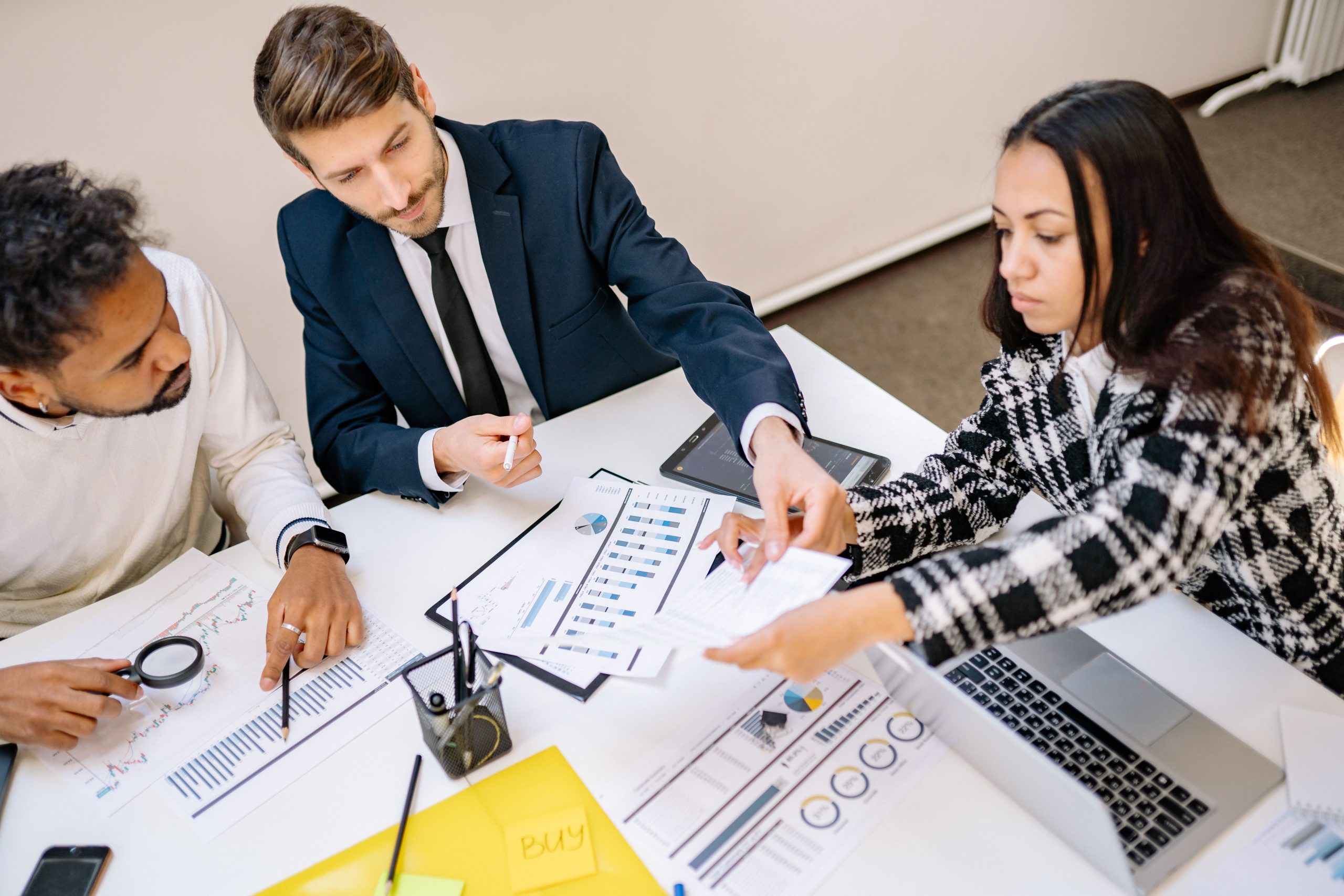 Business professionals reviewing charts and documents in a sustainability reporting meeting