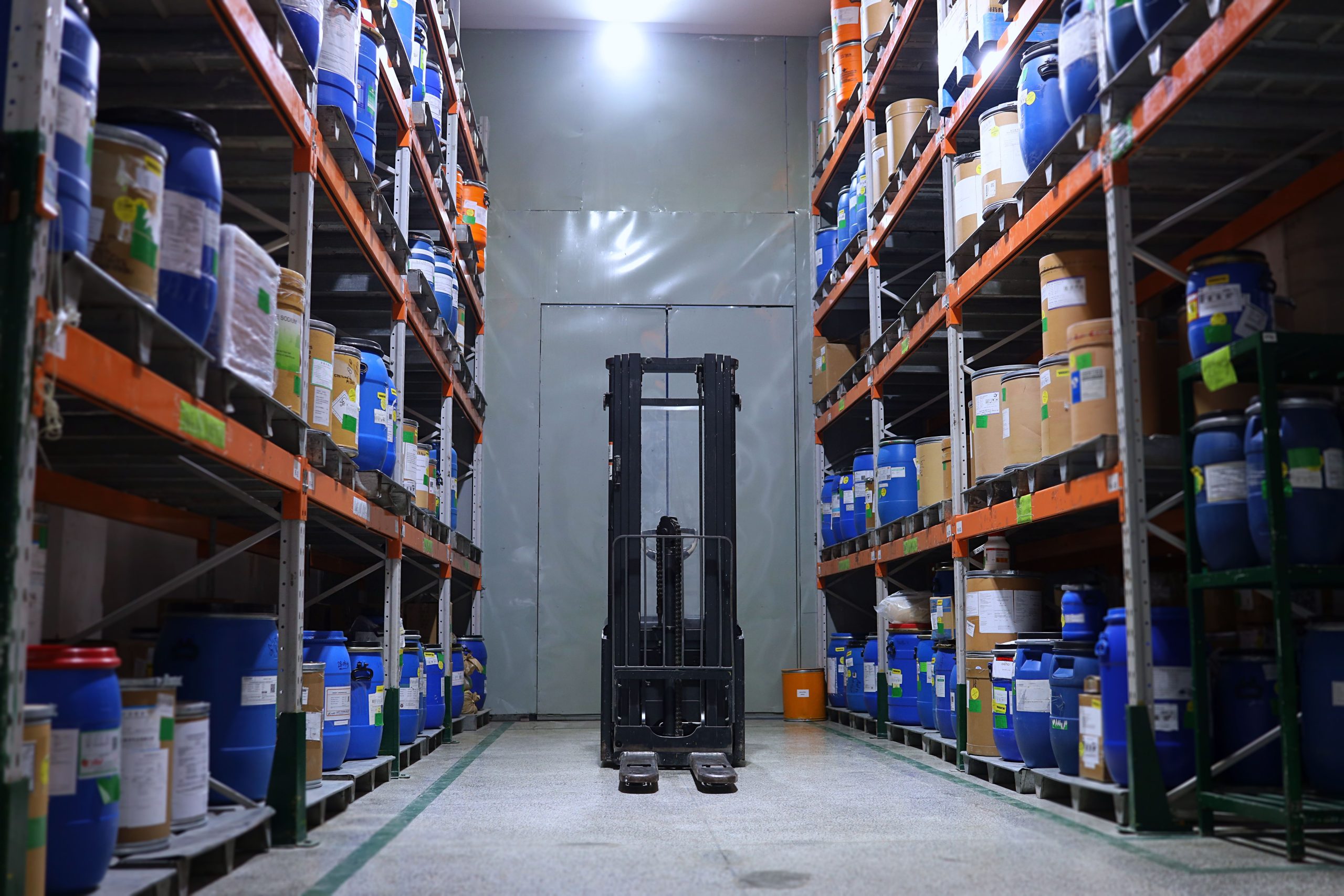 Well-organized chemical storage warehouse with stocked shelves