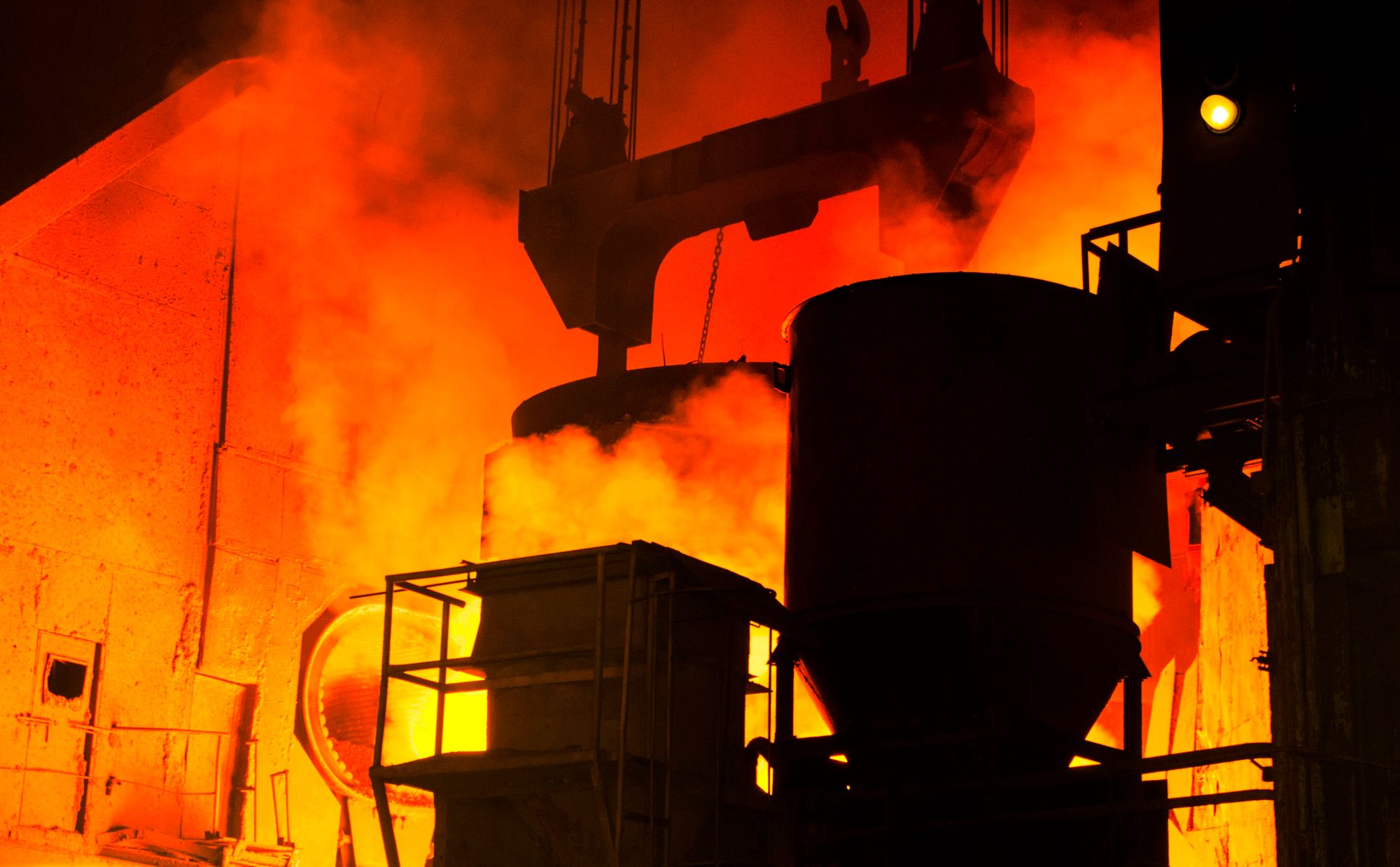 Interior of a steel mill with molten metal and intense radiant heat, an indoor work area covered by OSHA heat hazard enforcement